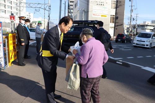 啓発グッツを配布する佐藤町長