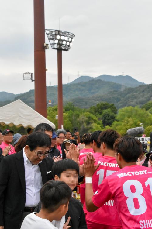 試合後、選手とハイタッチをする寺尾町長